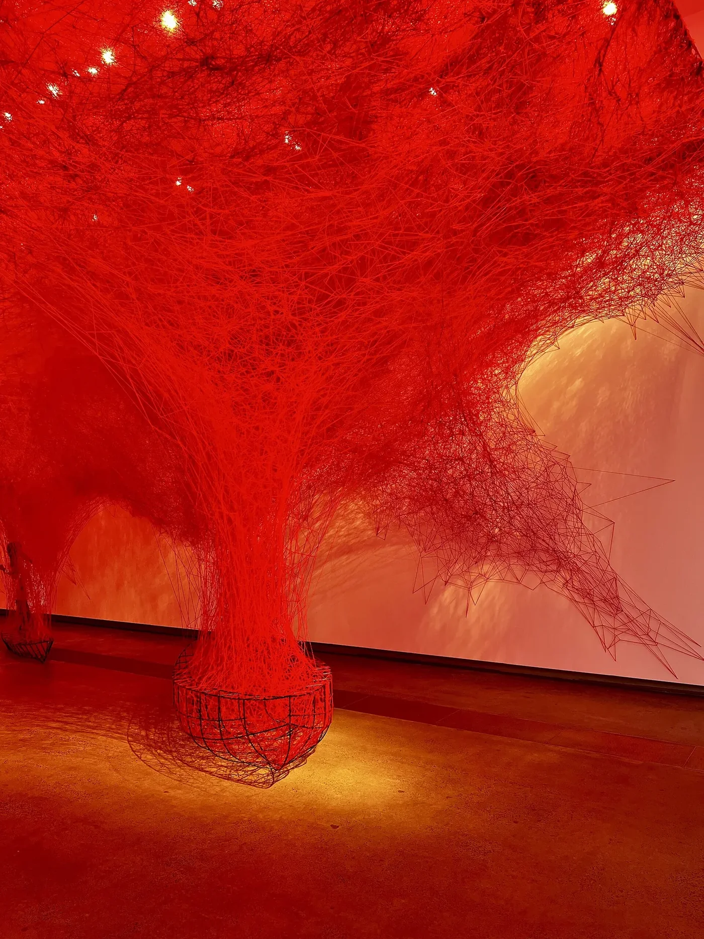 Chiharu Shiota’s Uncertain Journey, a dense red thread installation