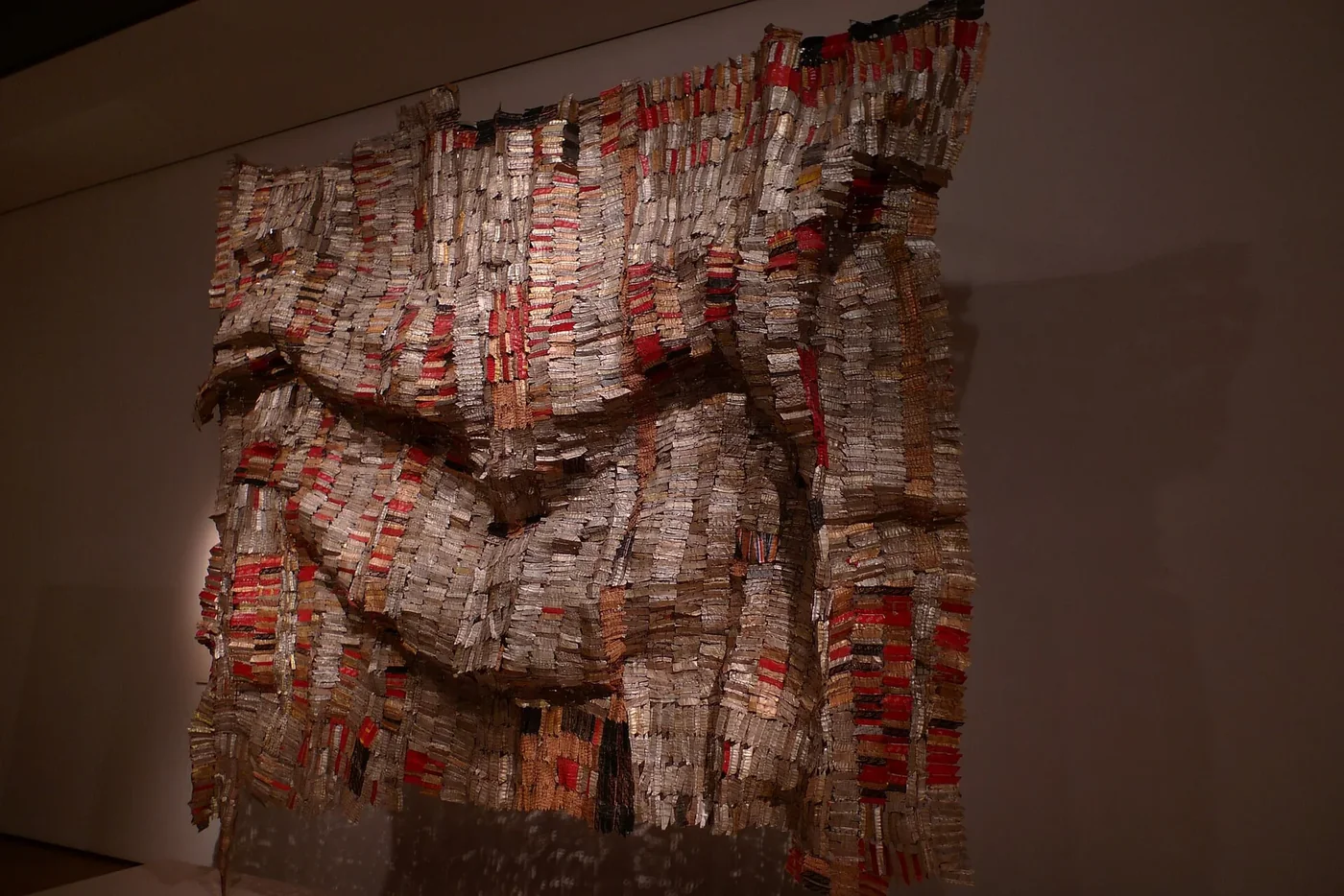 El Anatsui’s Man’s Cloth, a folded wall sculpture made from metal wrappers